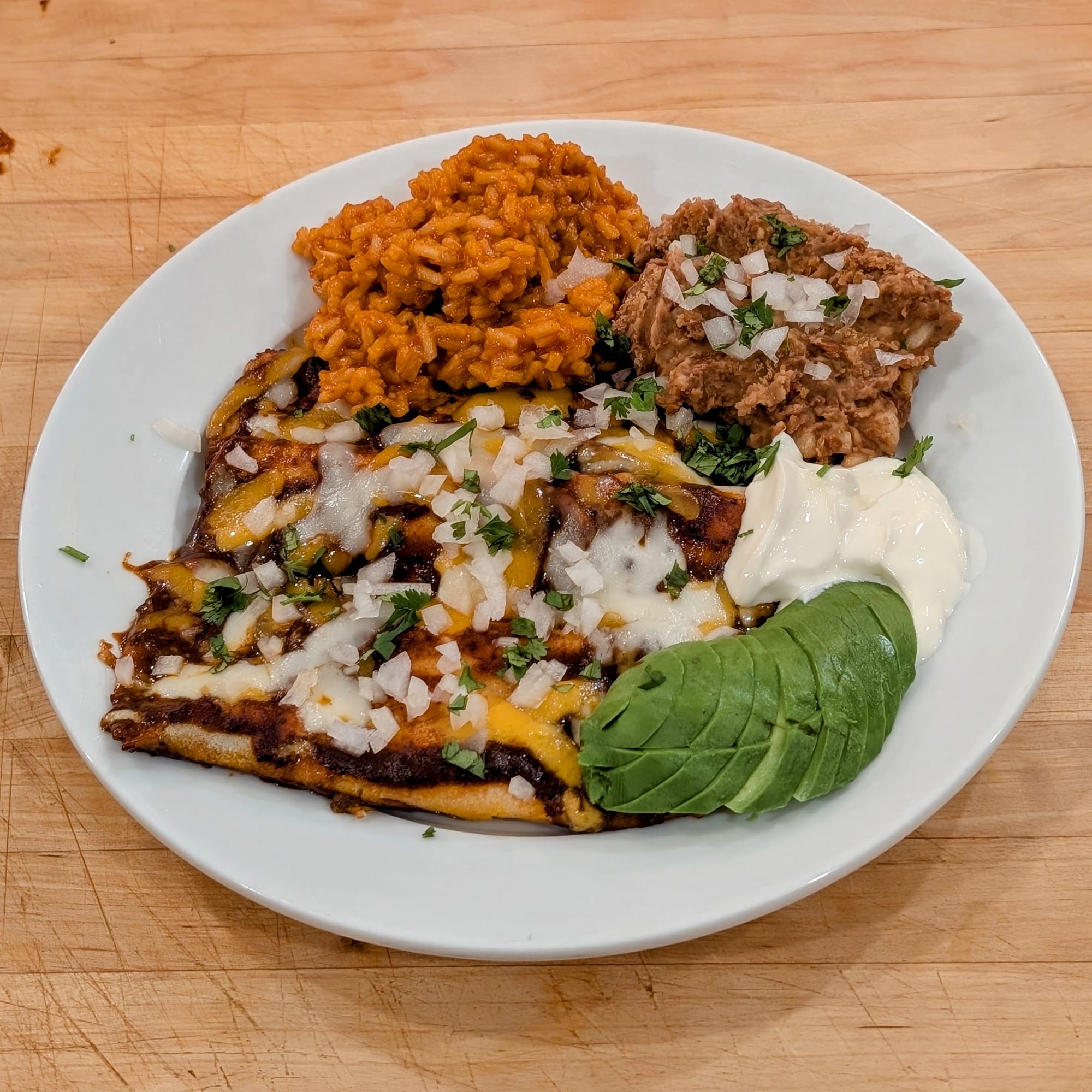 I know... I have used this action shot before. But damn this is a nice plate of Cheese Enchiladas, Mexican Rice and Refried Beans. Make this meal for yourself.