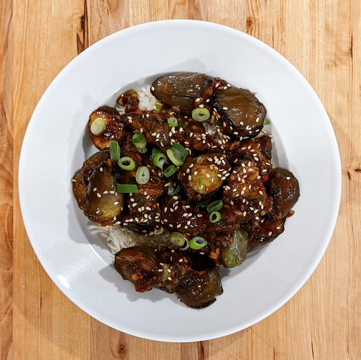 A well photographed dreamy Asian Eggplant in a bowl over basmati rice.