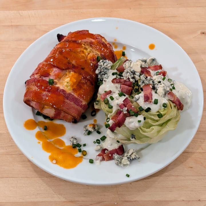 Plate of a Buffalo Chicken Griller, expertly garnished with a grilled lettuce wedge and my Blue Cheese Dressing.