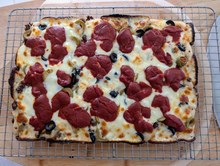 Whole 10 x 14 hamburger, with black and green olive Detroit Style Pizza.