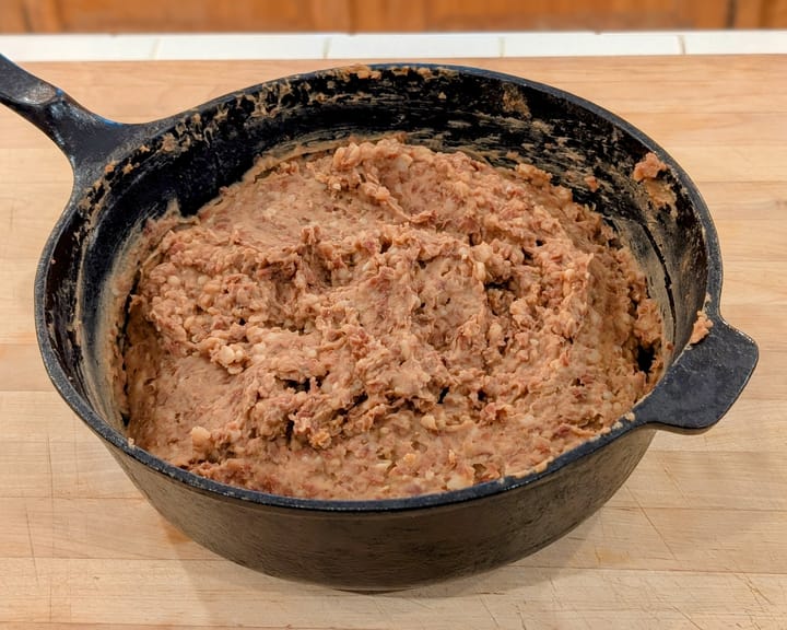 This black iron skillet of Refried Beans will make a great side tonight and freeze some for later.